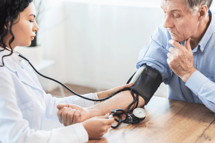 Healthcare professional checking a man's blood pressure before starting testosterone replacement therapy to monitor cardiovascular health.