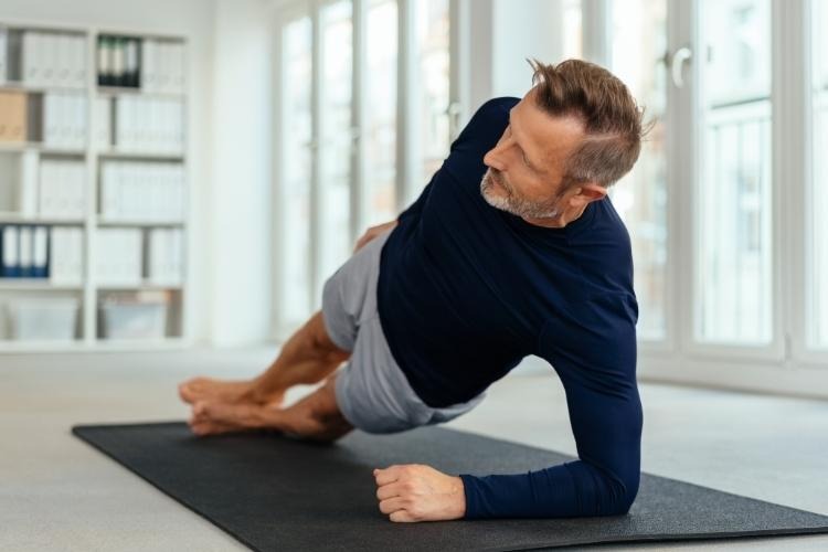 Middle-aged man doing resistance training for healthy muscles