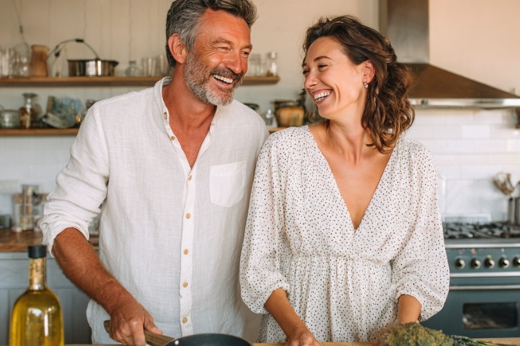 Happy mature couple cooking together.