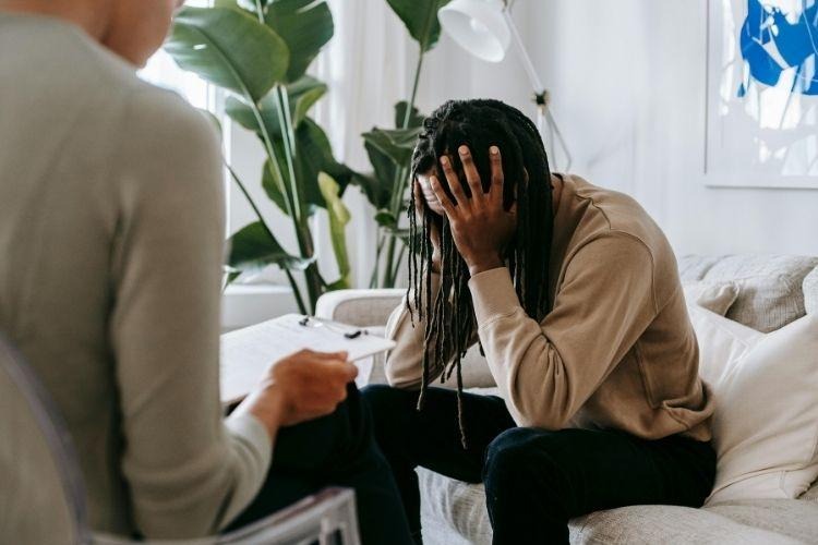 Man discussing persistent anxiety with a mental health professional as part of comprehensive mental healthcare.