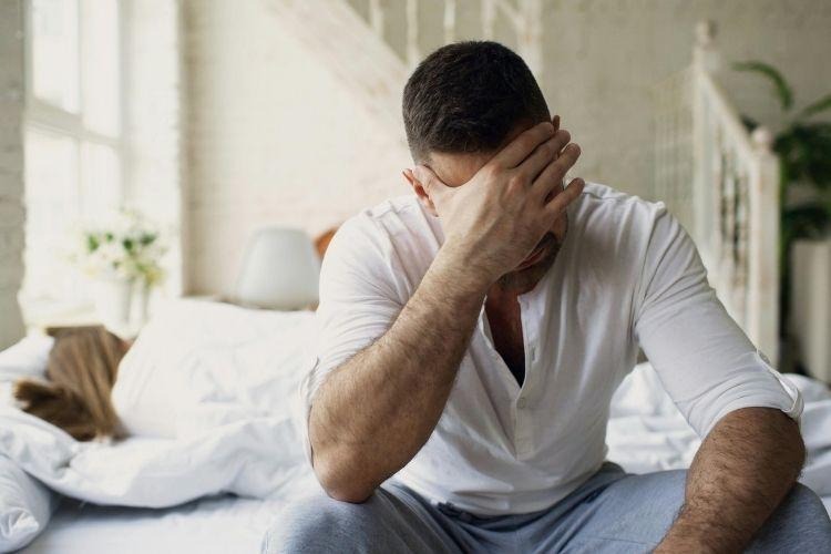 Man experiencing anxiety, fatigue, and mood instability, symptoms that can overlap with low testosterone.