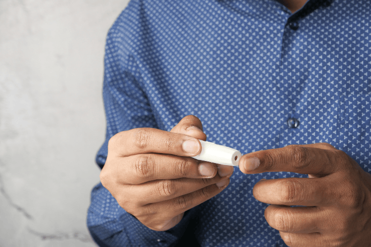 Man holding a testosterone treatment applicator in his hands.
