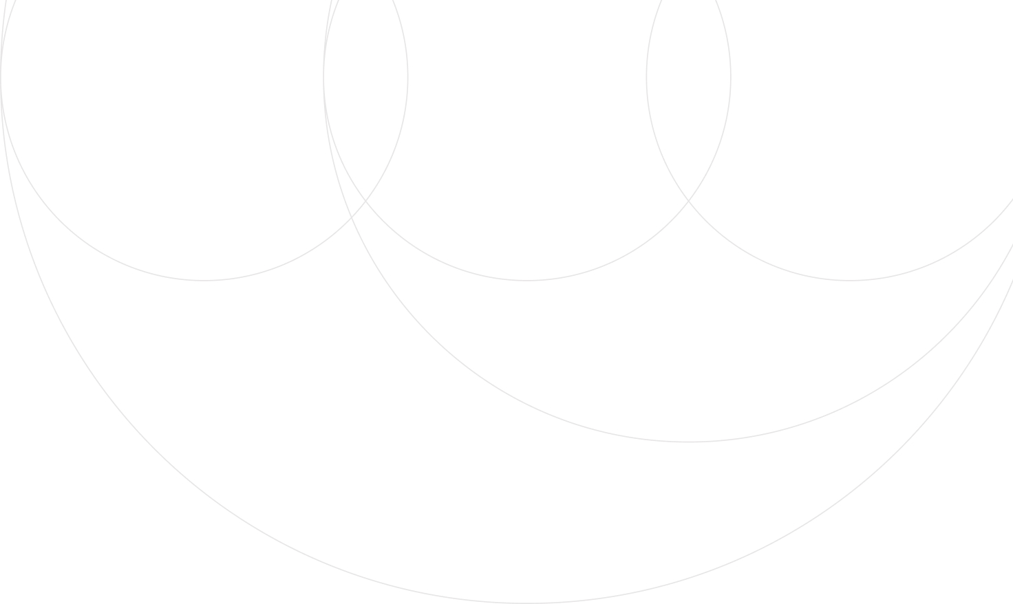 Mountain landscape with bright sun rising over peaks and partially cloudy blue sky.