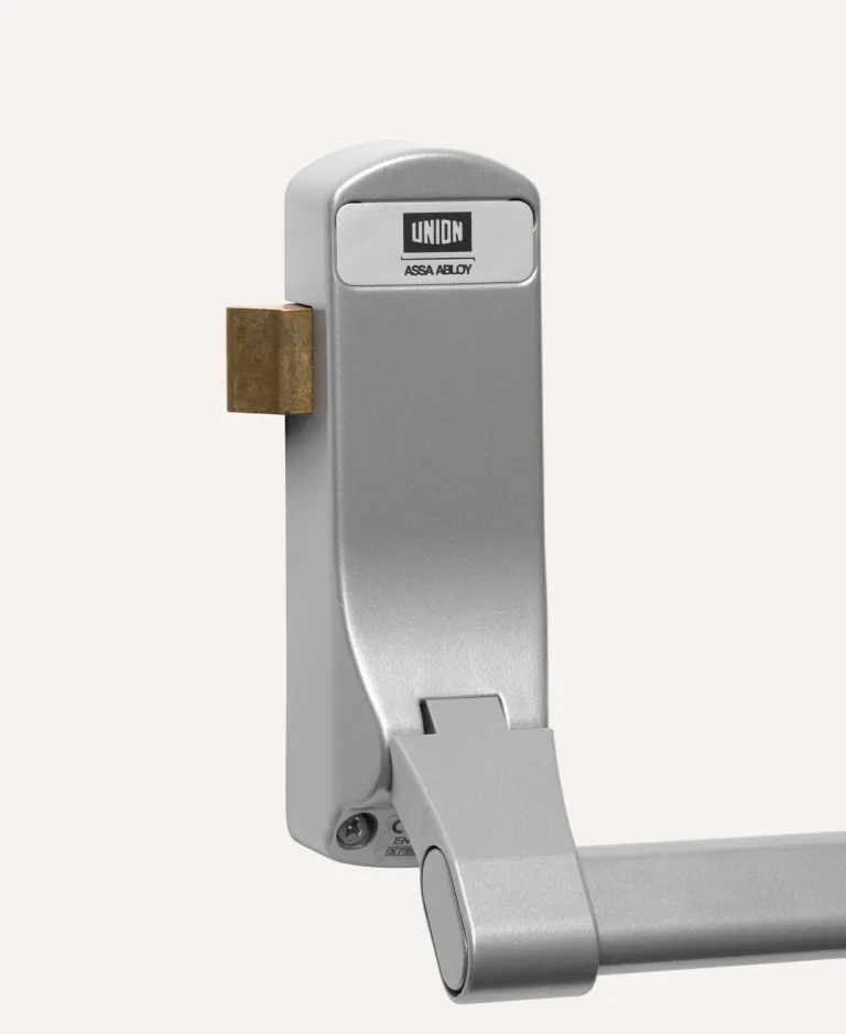Close-up of a silver UNION ASSA ABLOY panic bar door lock.