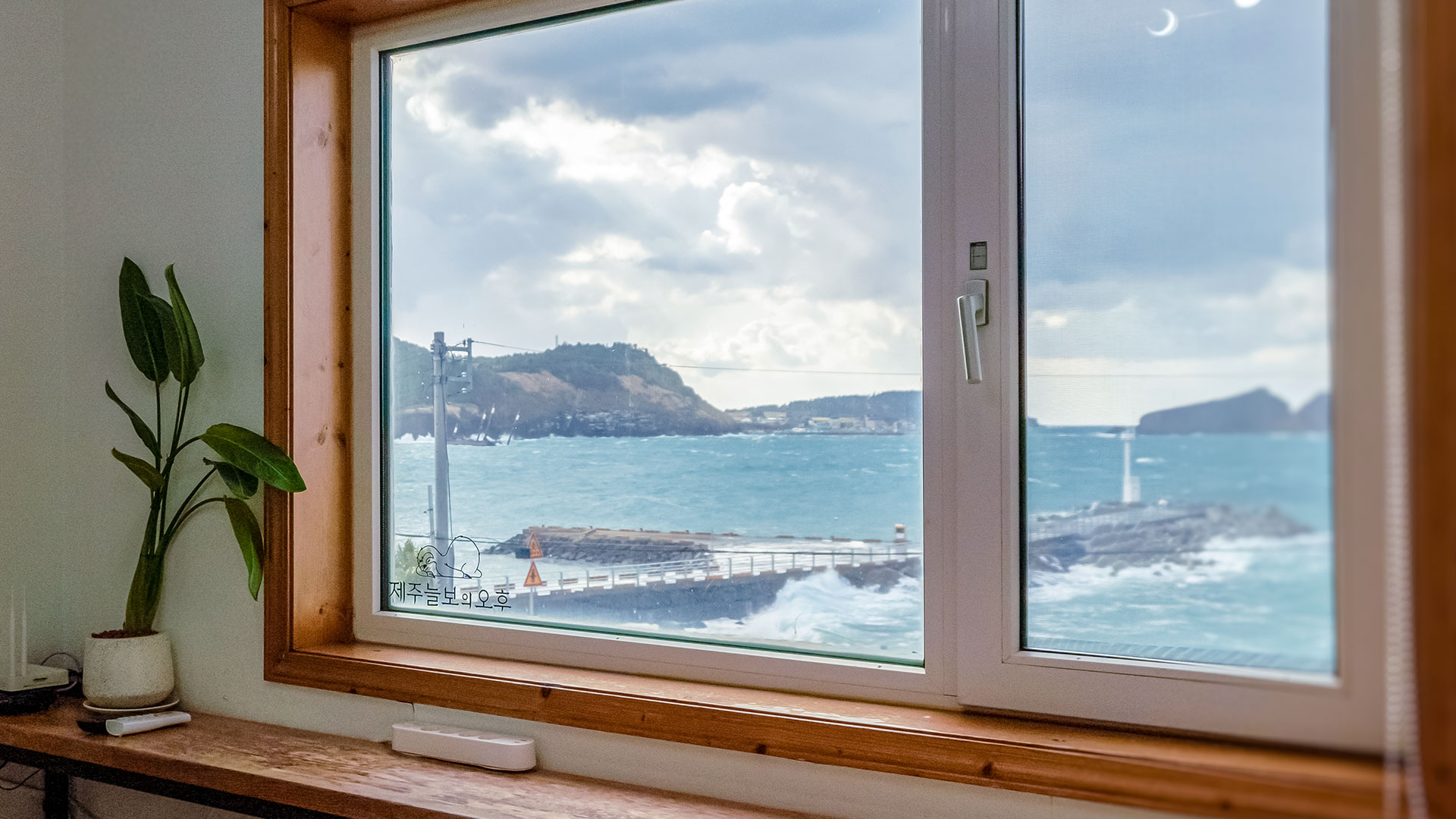 '제주늘보의오후' 2층 패밀리룸 객실중 큰방  창밖으로 보는 바다와 차귀도의 모습.
The view of the sea and Cha Guido Island looking out the window of the large room in the family room on the 2nd floor of 'JEJUNEULBO'.