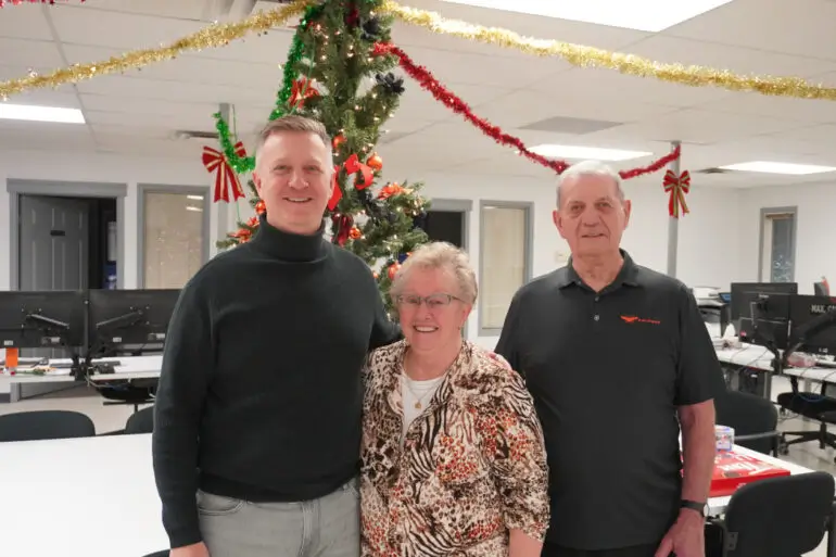 Logo with the text 'WHOLE GRAIN' featuring a stylized grain icon inside the letter O and 'PRESENTED BY GEAPS' below on a background of stylized grain fields and silos.