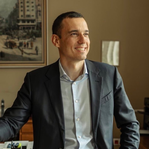 Portrait photograph of a woman with long hair, smiling.