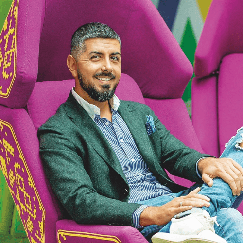 Portrait photograph of a woman with long hair, smiling.