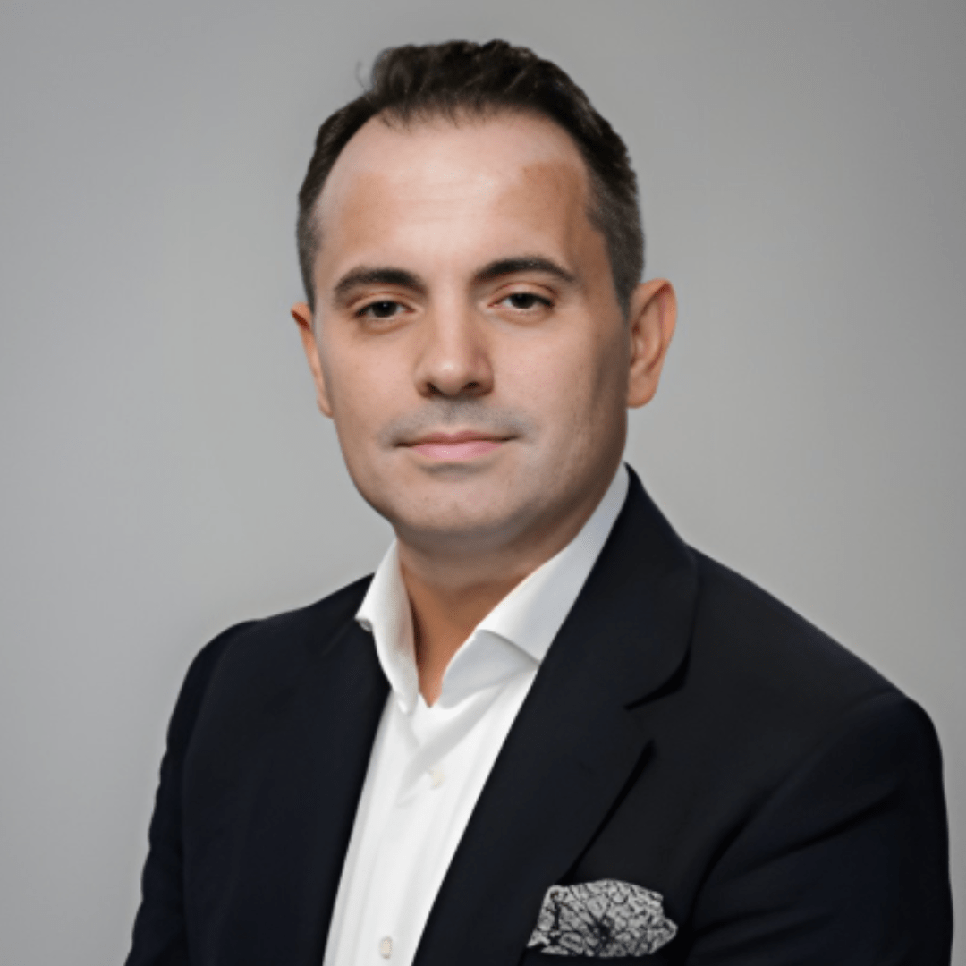 Portrait photograph of a woman with long hair, smiling.