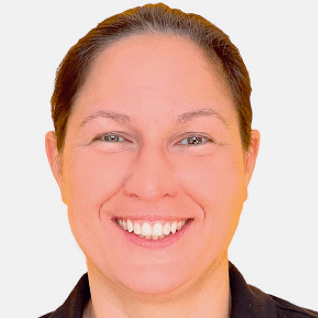 Portrait photograph of a woman with long hair, smiling.