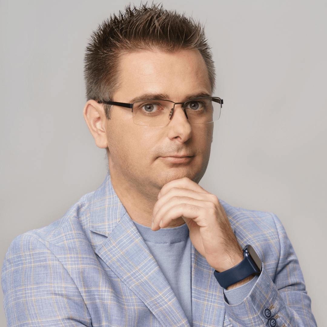 Portrait photograph of a woman with long hair, smiling.