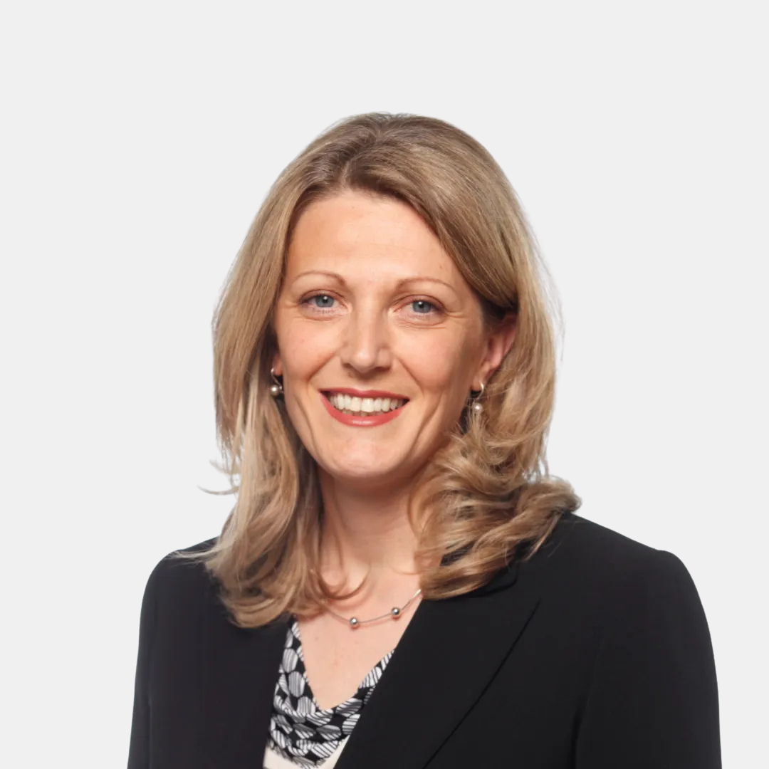 Portrait photograph of a woman with long hair, smiling.