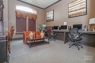 Business room with computers, desks, and chairs