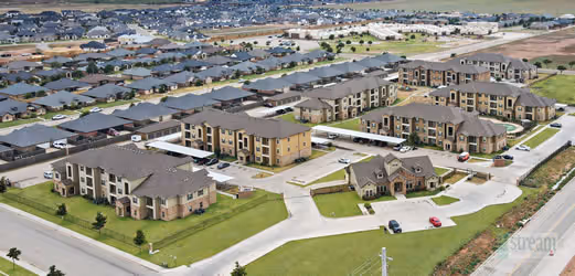 birds eye view of apartments and surrounding area