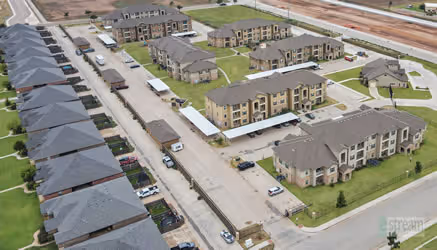 birds eye view of apartments and surrounding area