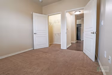 bedroom with closet and view of hallway