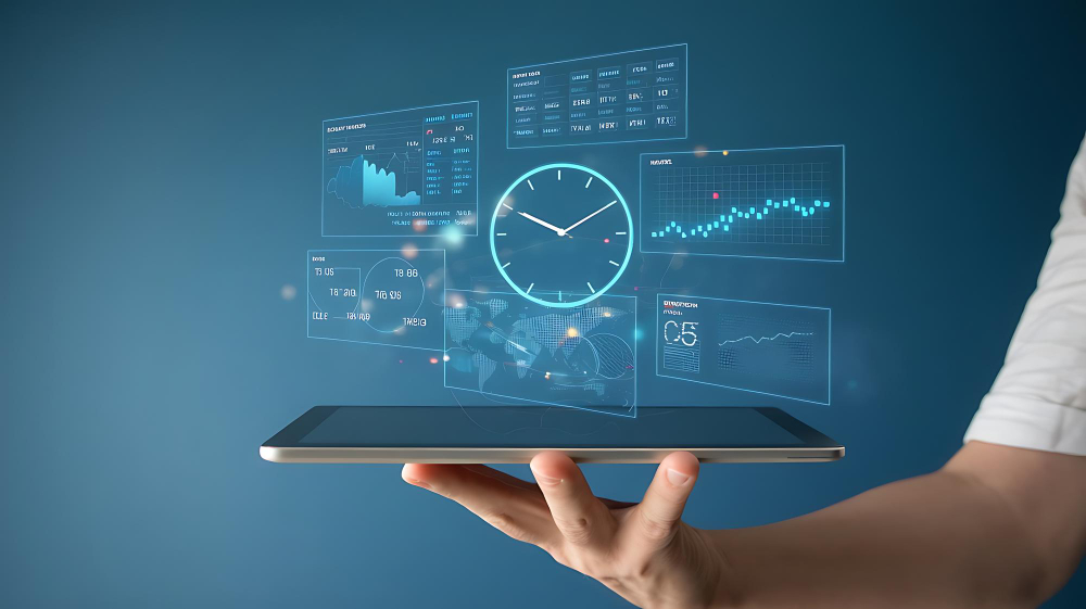 Hand holding a tablet displaying a holographic interface with a clock and various data charts.