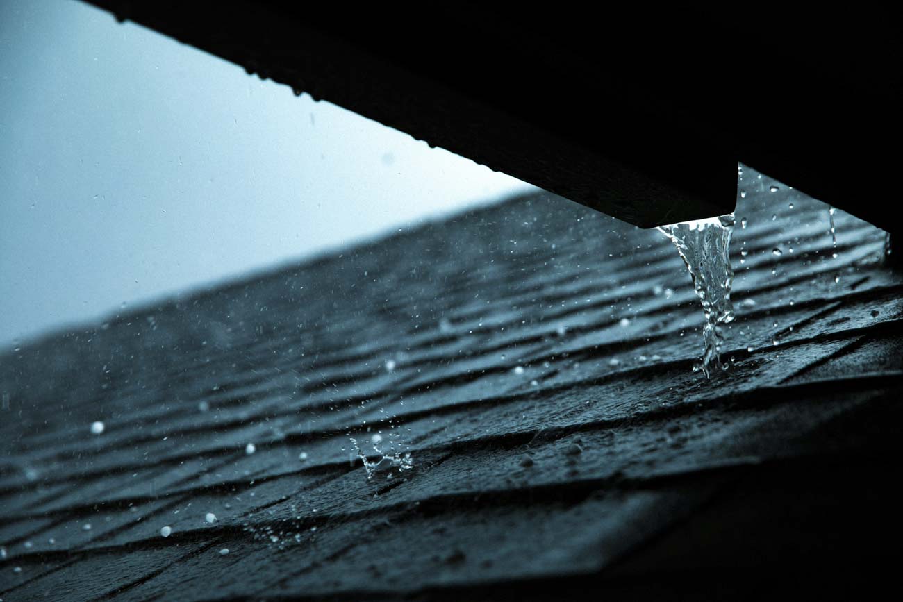  Rainwater draining from roof during a winter shower