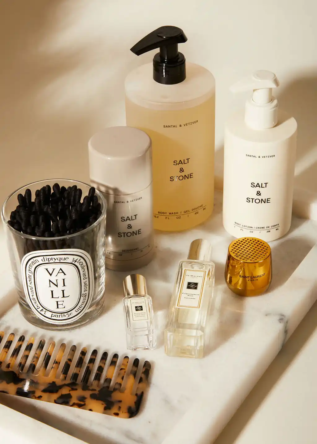 A white tray topped with lots of different types of beauty products.