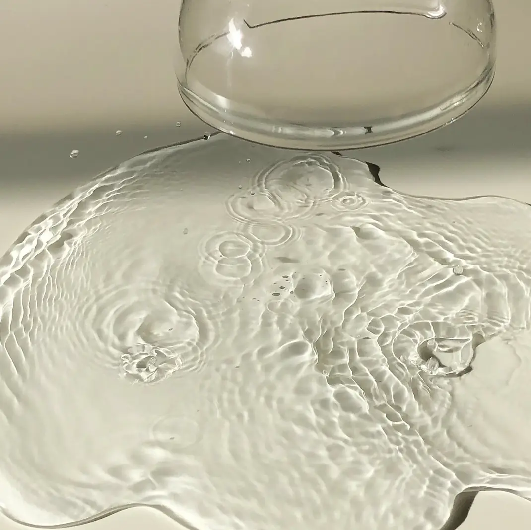 A glass bowl with a liquid inside of it.