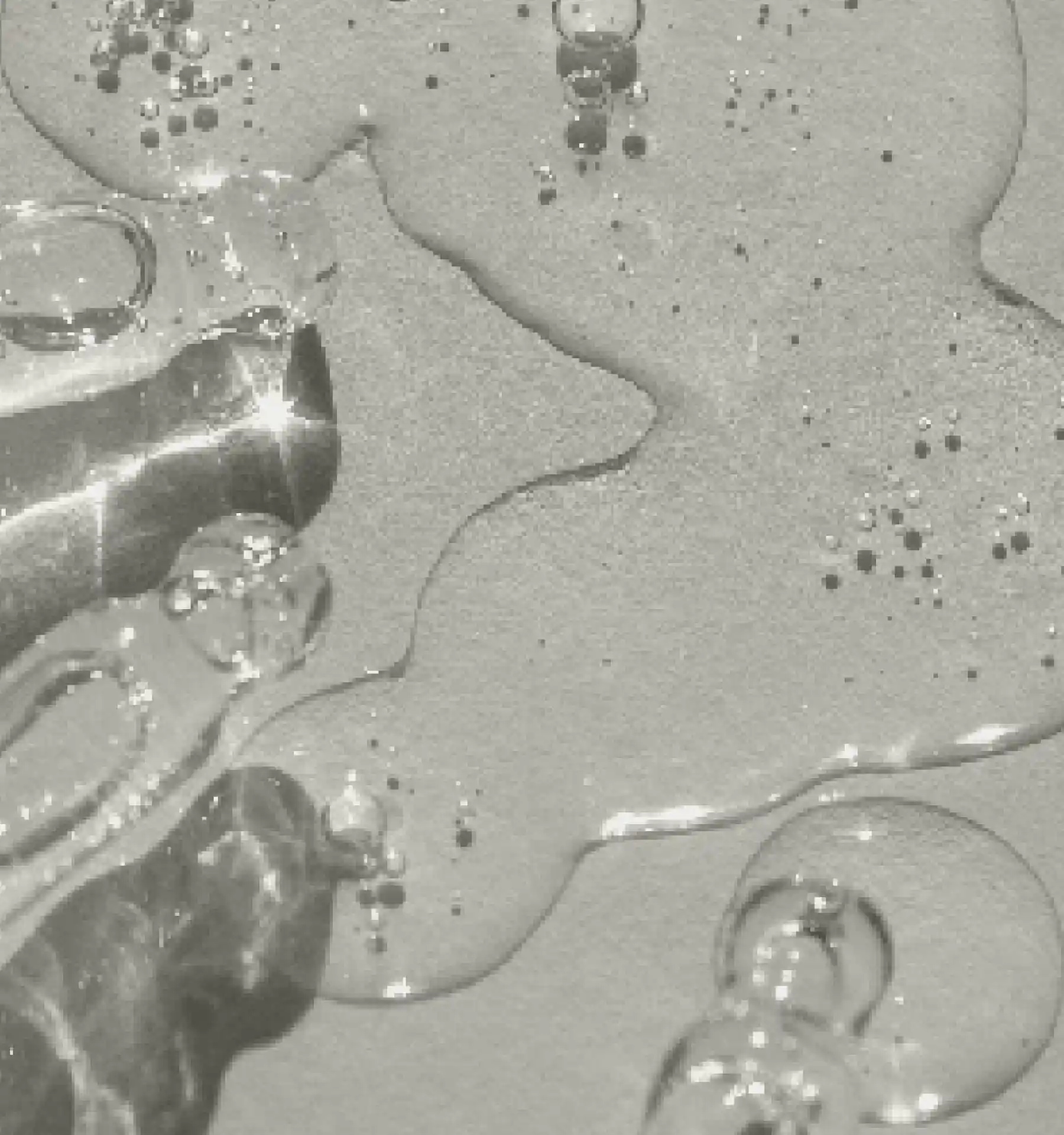 A close up of water bubbles in a sink.
