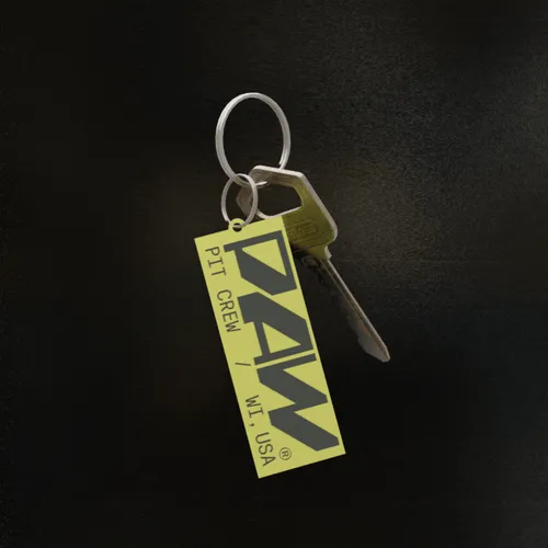 Silver key attached to a keyring with a yellow tag labeled 'PAW PIT CREW / WI, USA'.