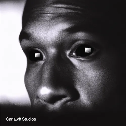 Close-up of a grayscale face with large, dark eyes reflecting a logo-shaped light source.