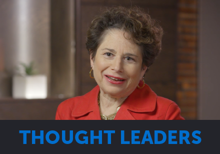 A woman in a red jacket speaks, labeled "THOUGHT LEADERS" at the bottom.