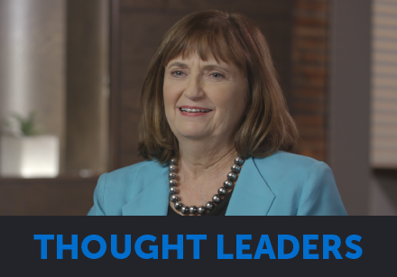 A woman with brown hair in a turquoise blazer speaks about thought leadership in digital health.