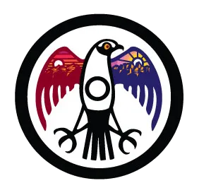 Circular emblem featuring a stylized black bird with outstretched wings; left wing shows a red sunset over mountains and right wing shows a blue sunrise over mountains.