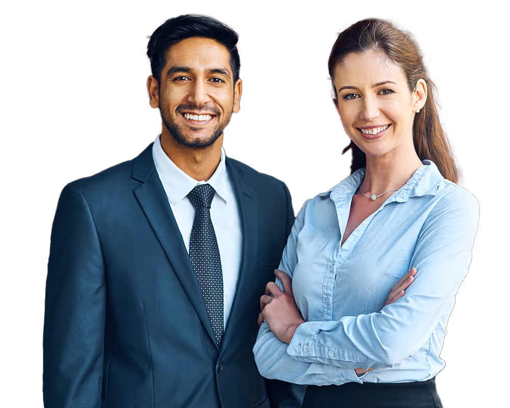 Smiling man in a dark suit and tie standing next to smiling woman in a light blue shirt with arms crossed.