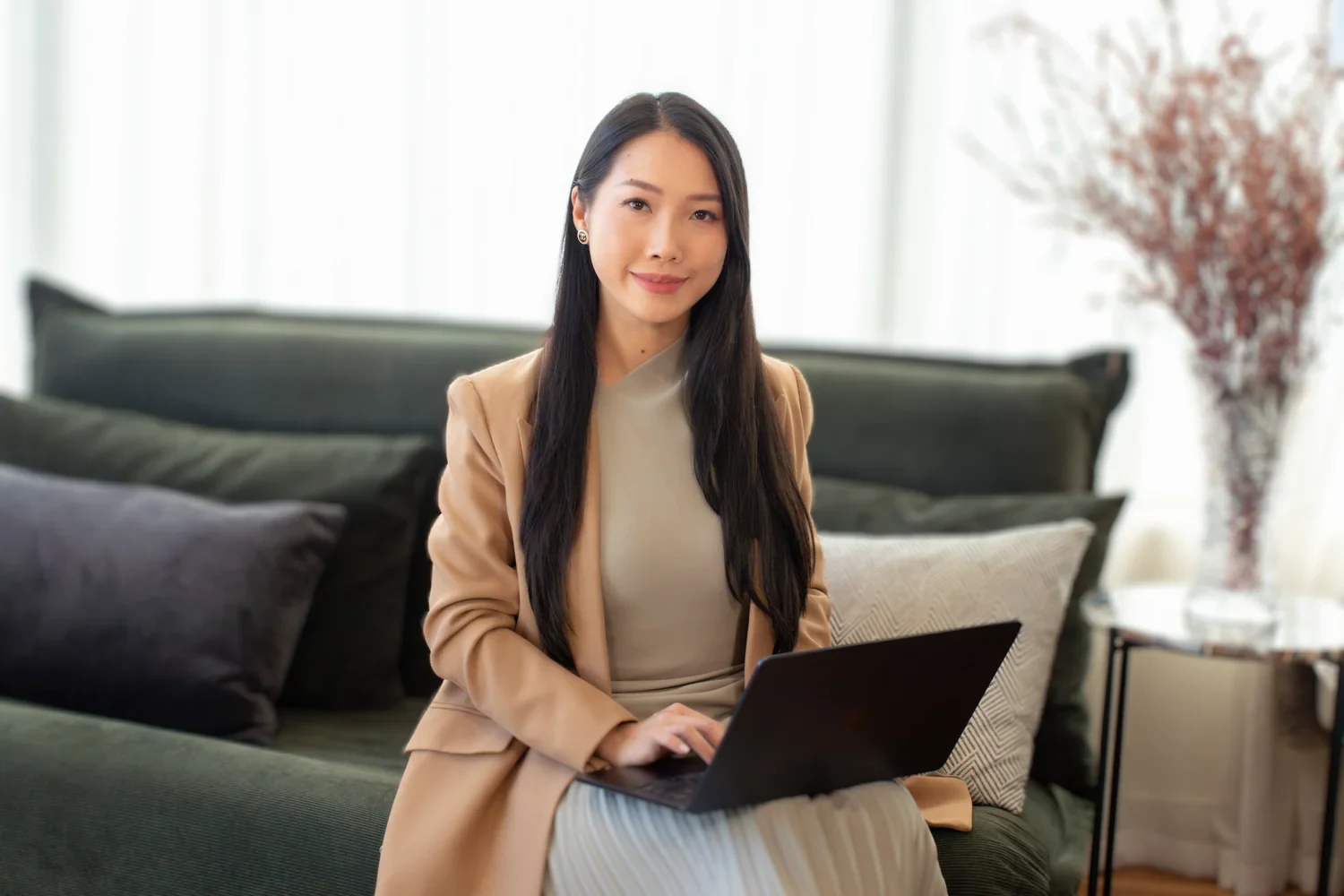 Sarah Hien Tran of GlamJet working with a laptop