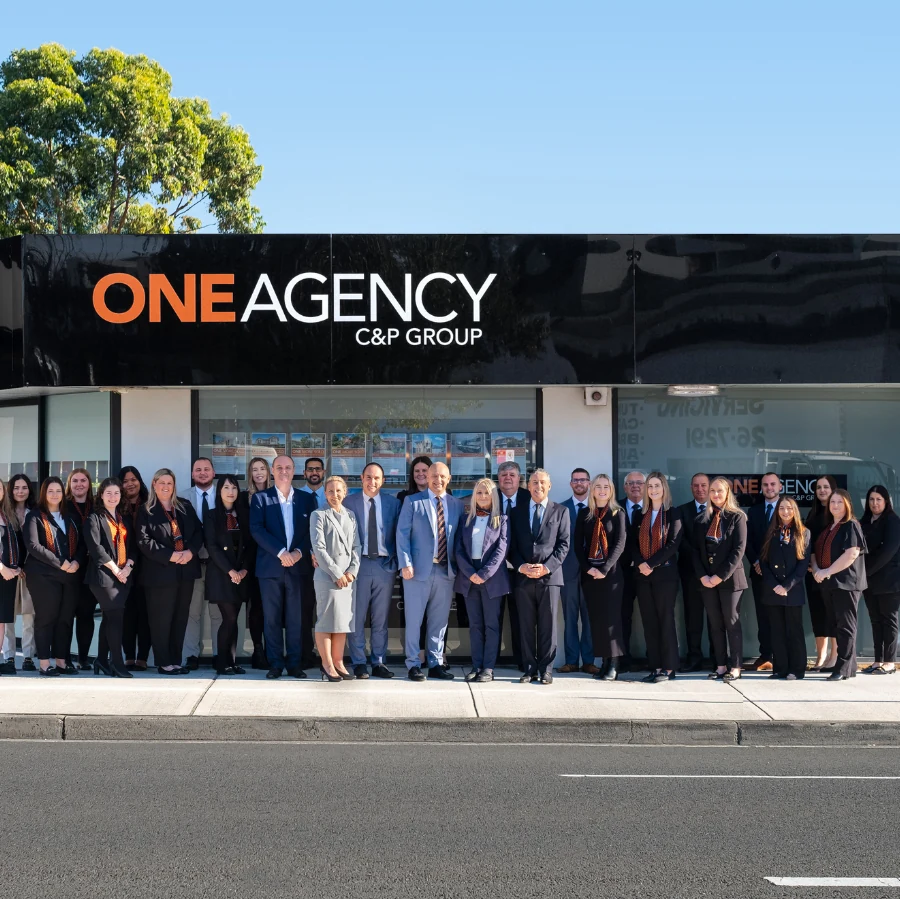 The One Agency team outside their office