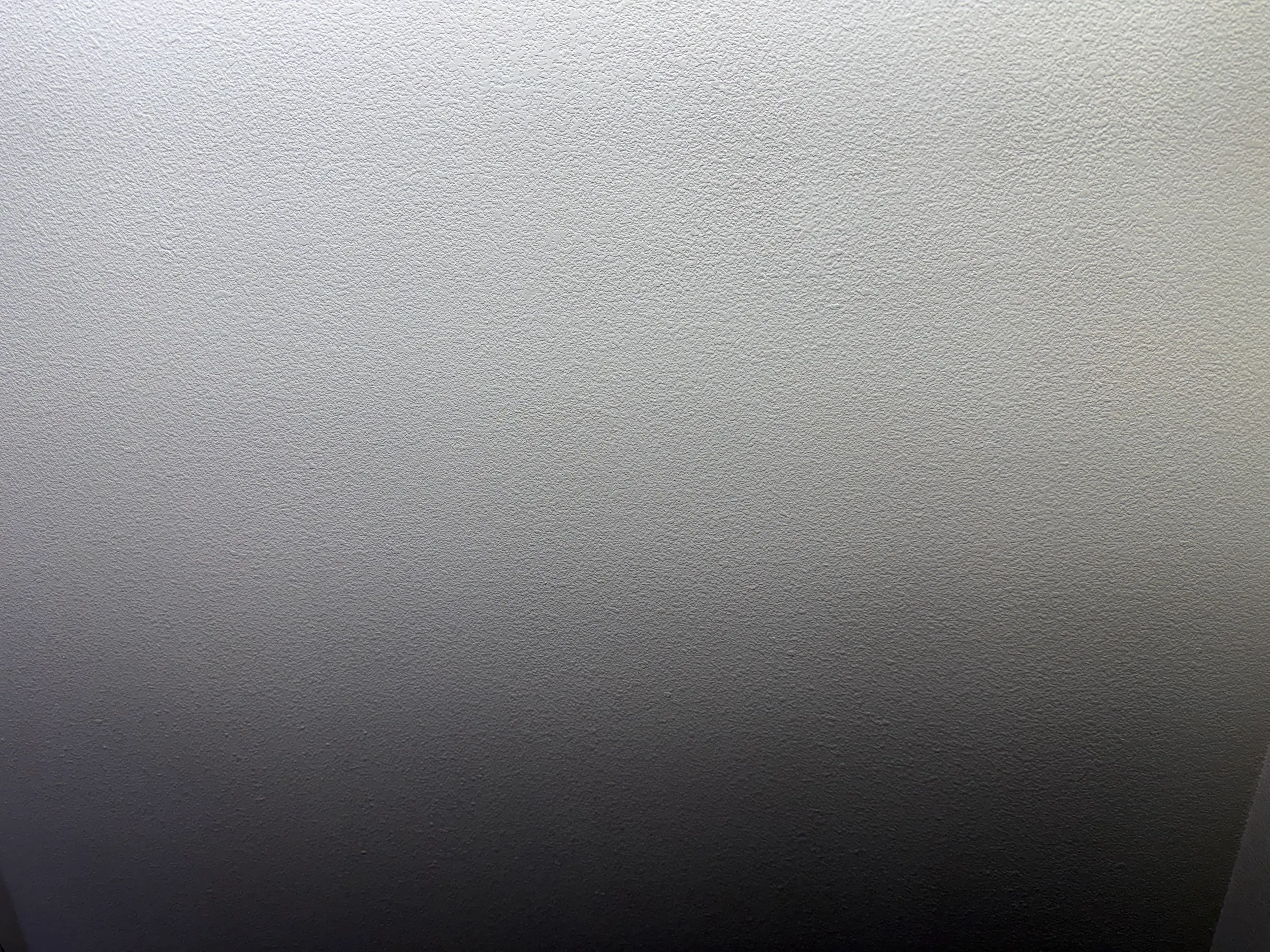 Close-up of finished wall texture showing repaired and painted interior surface.