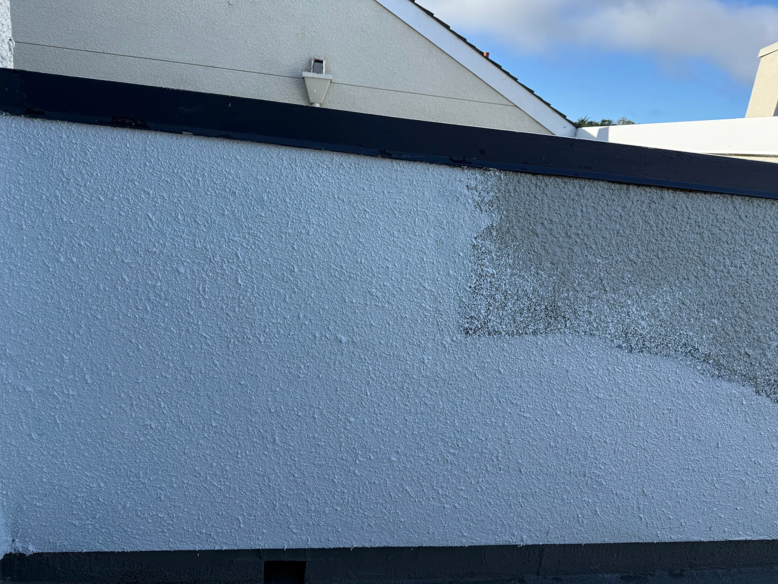 New acrylic wall texture blended into existing stucco to match the original exterior finish.