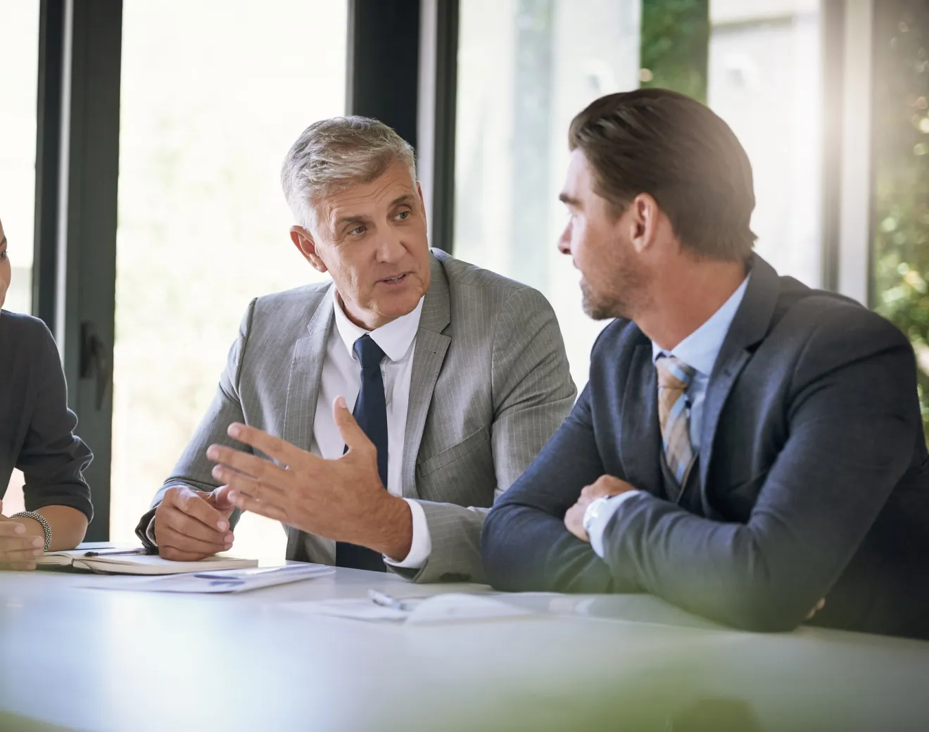 Two businessmen talking at a table