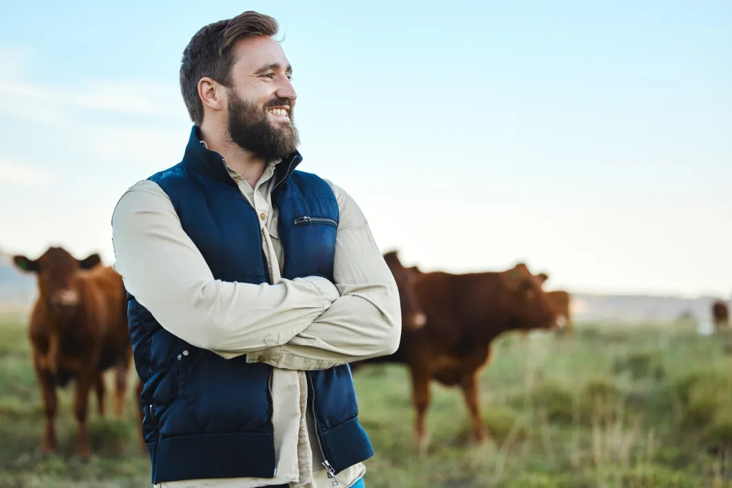 Man smiling while standing in a farm field