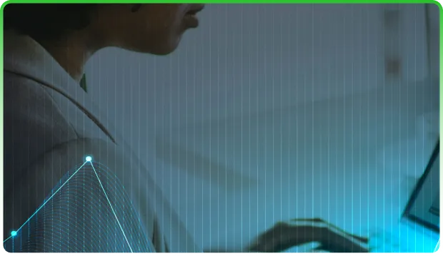 Person working on a laptop with a digital graph overlay representing data analysis.