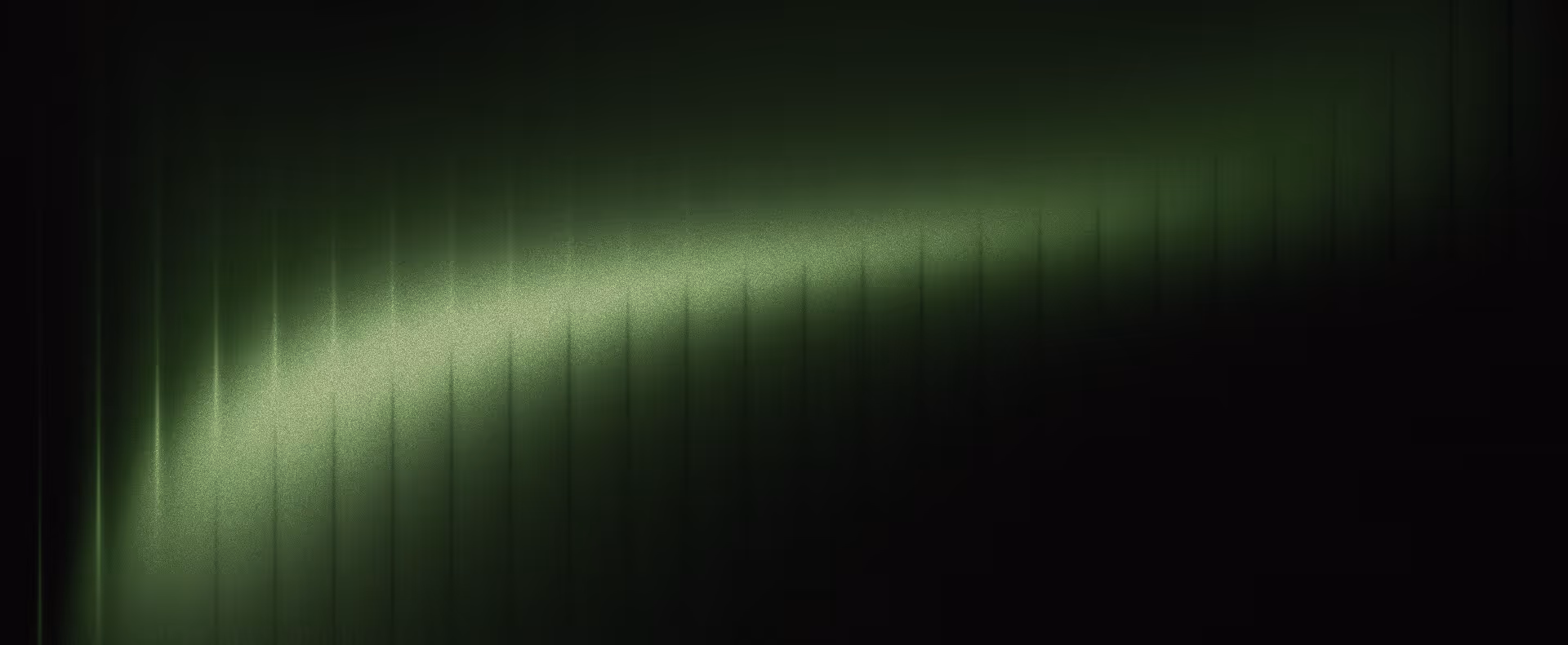 Abstract dark background with a diagonal gradient glow of green light fading into black.