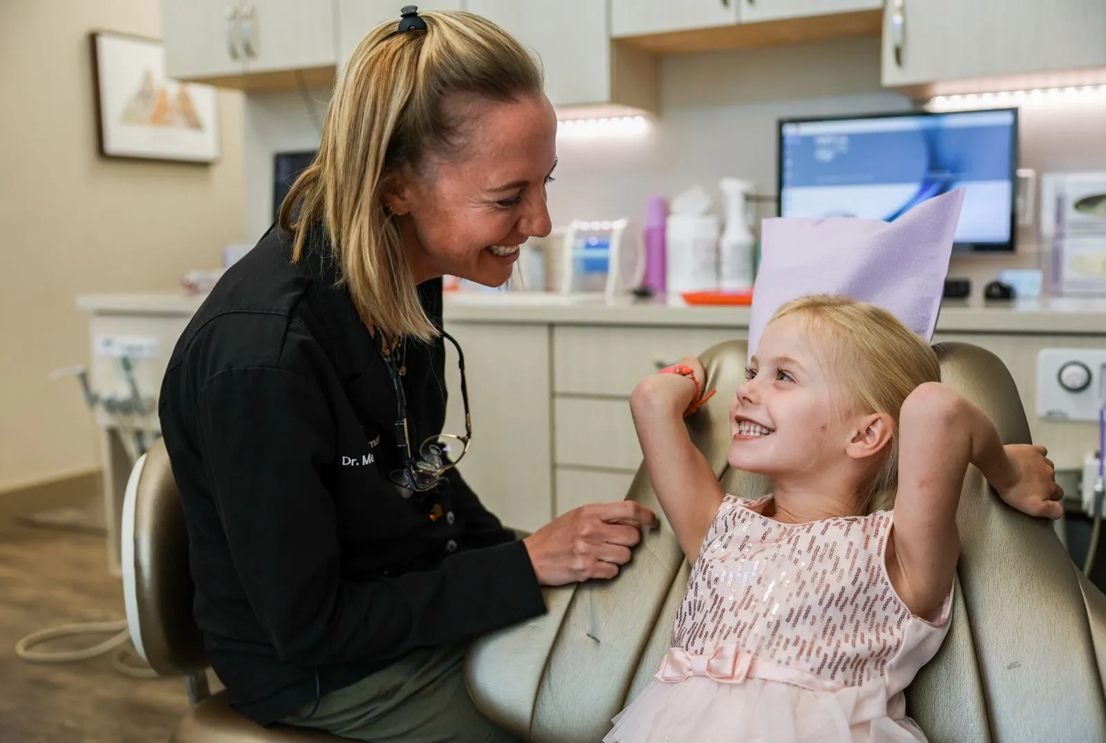 Pediatric Dentist Smiling with Young Girl