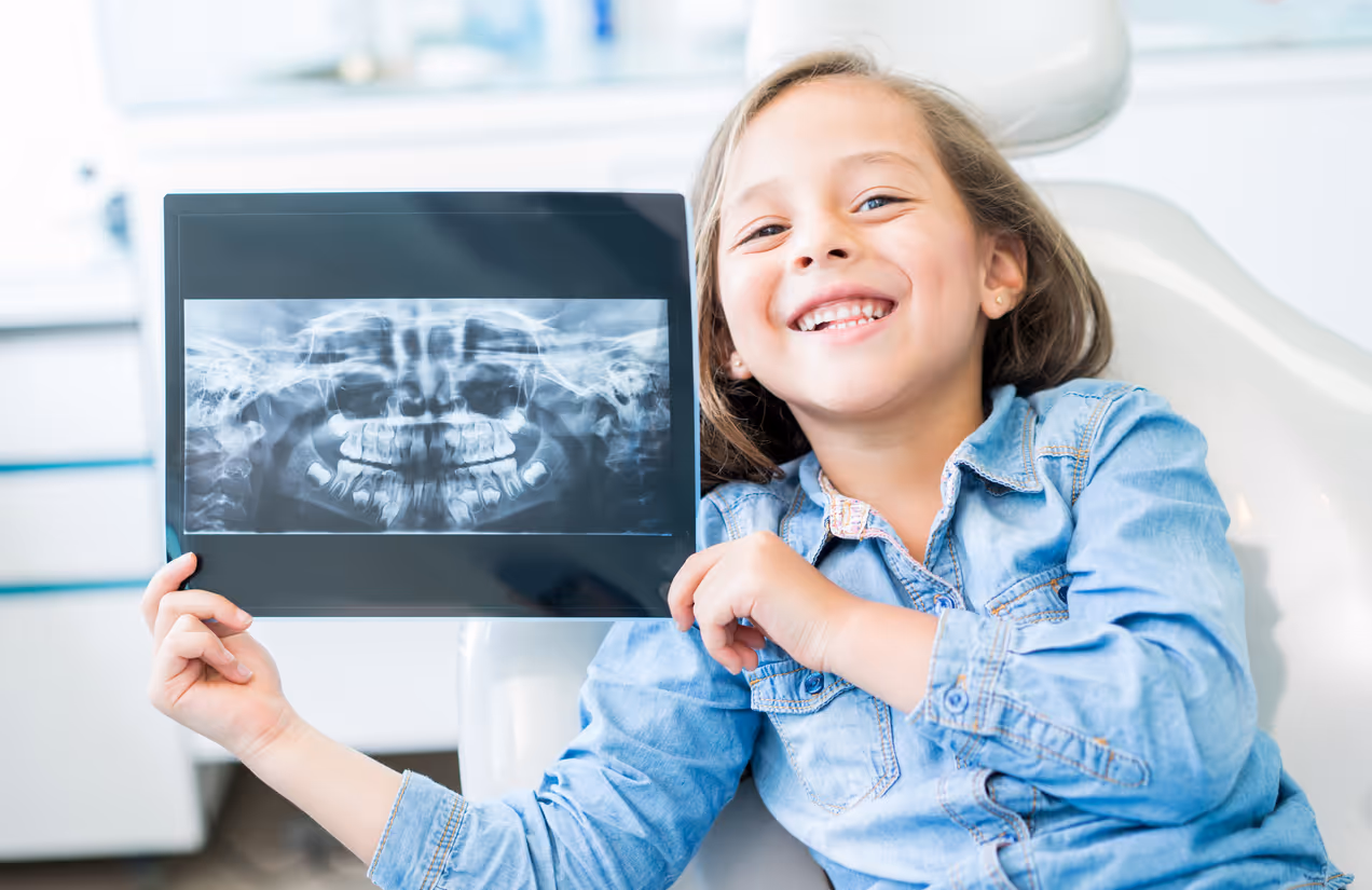 Young girl holding a dental x-ray
