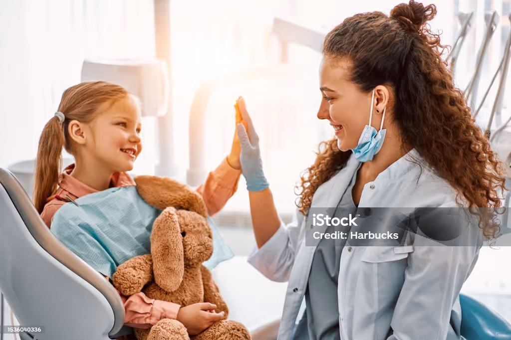 Dentist and patient high five