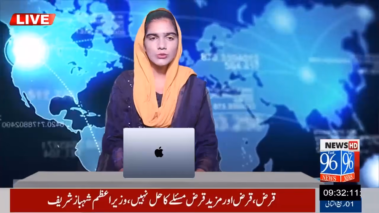 Female news anchor wearing a yellow headscarf presenting live news with a map background and a laptop.