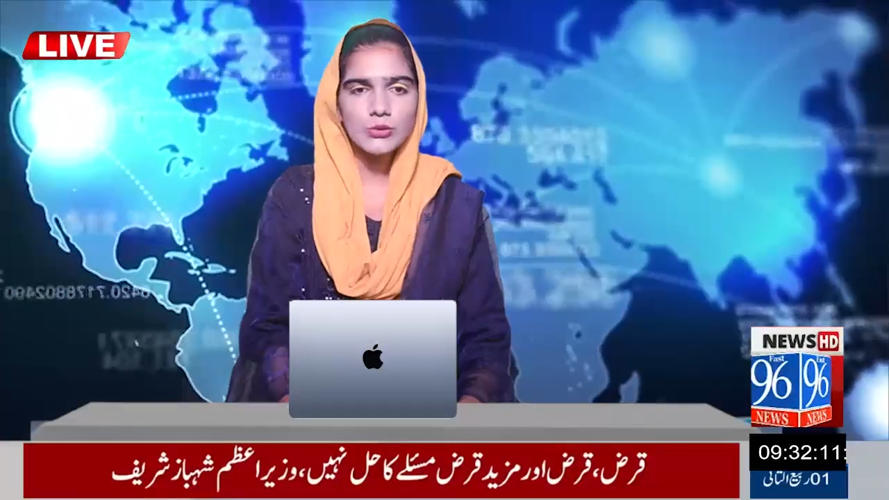 Female news anchor wearing a yellow headscarf presenting live news with a map background and a laptop.