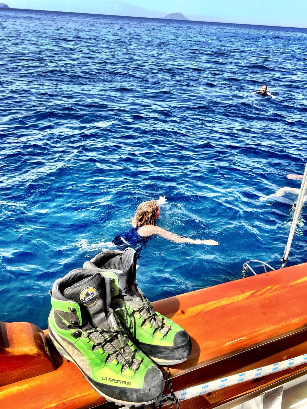 Hiking boots on deck while guests swim