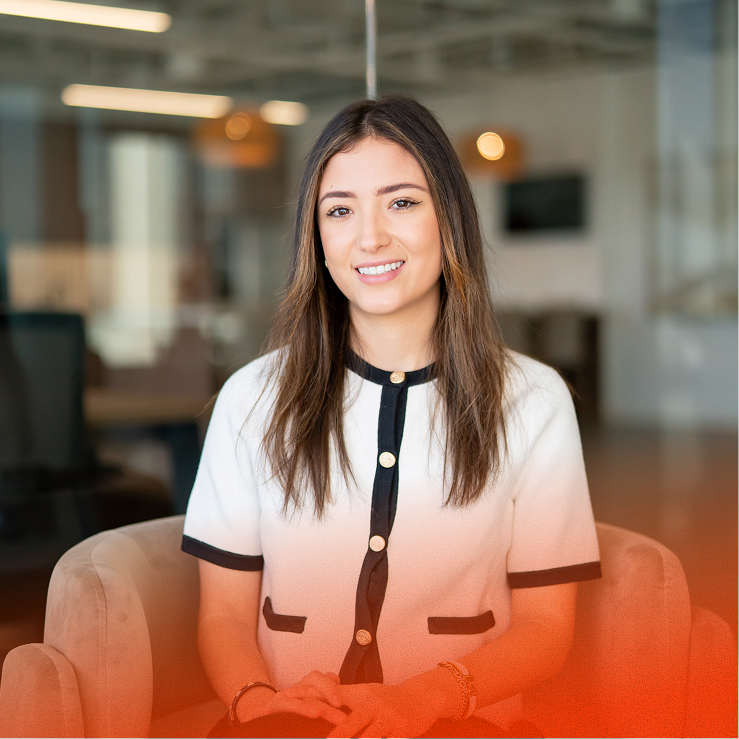 Young woman smiling and sitting in a modern office lounge
