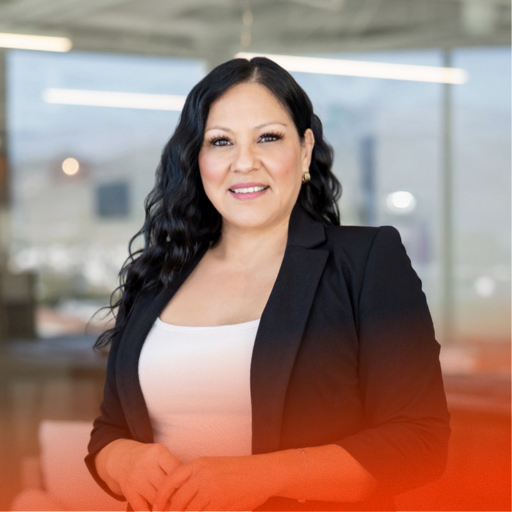 Businesswoman smiling, standing with hands clasped in bright office
