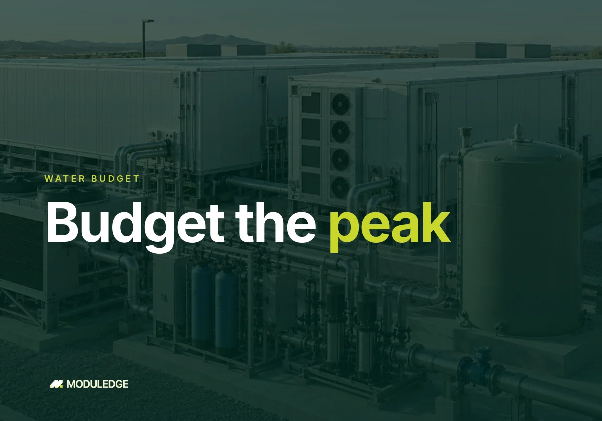 Data center water plant with a storage tank, pumps and a large supply main next to dry coolers in an arid location.