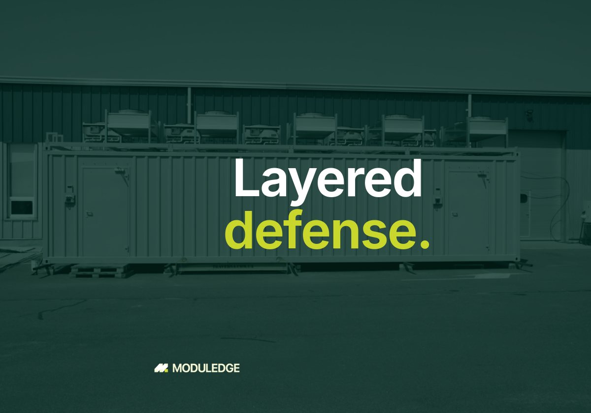 Long side of a white modular data-center container beside an industrial building, with the headline "Layered defense."