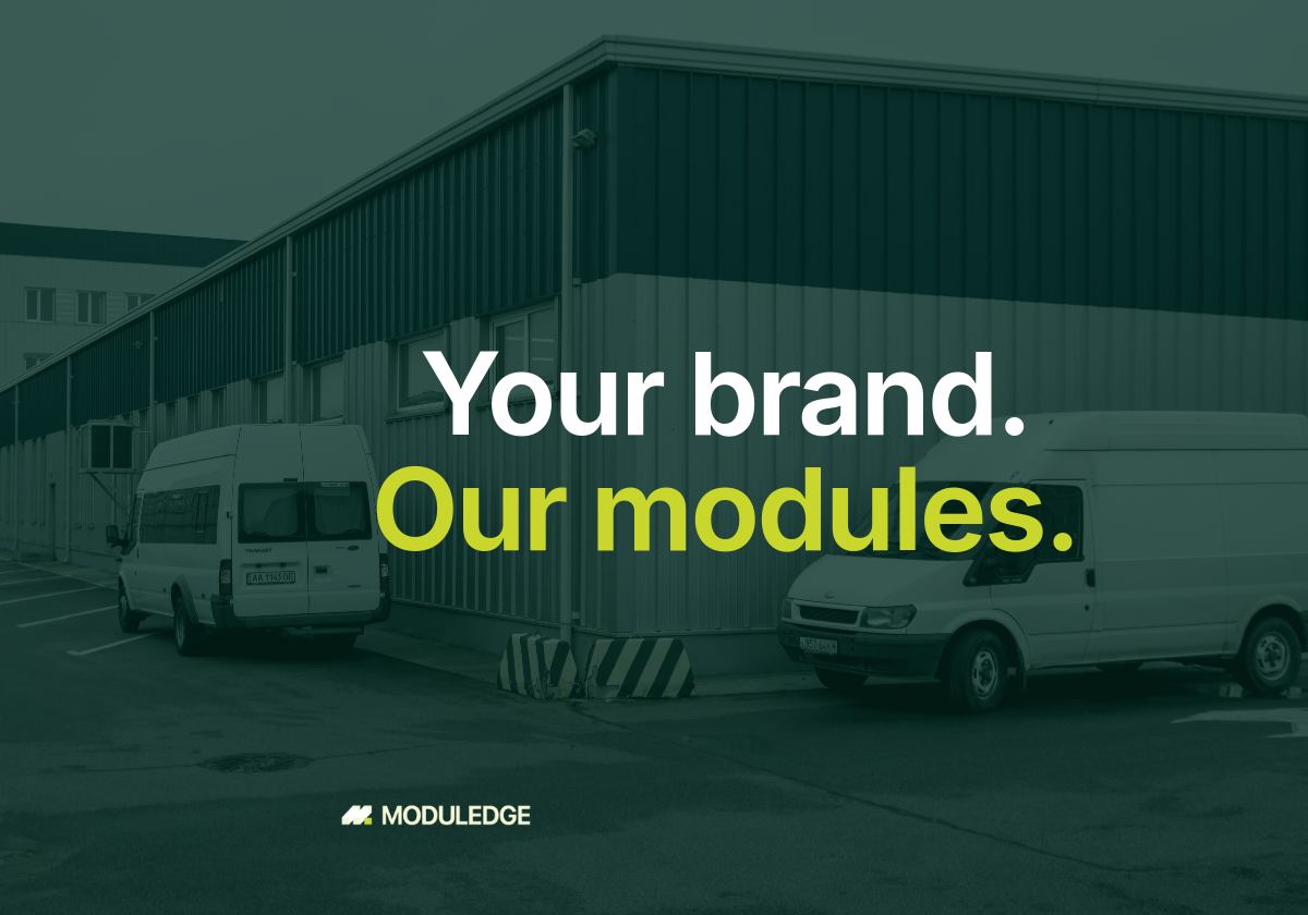 Blue-and-white industrial manufacturing building, with the headline "Your brand. Our modules."
